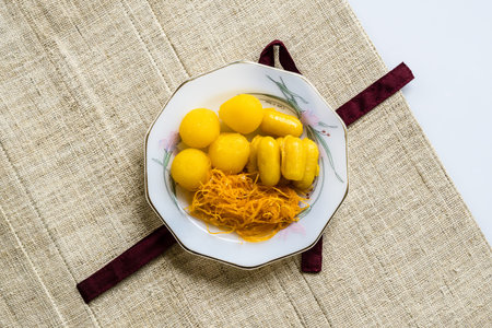 Thai Dessert - Sweet egg floss and egg yoke fudge balls cooked in syrup