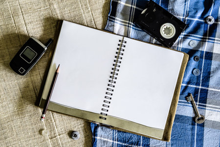 Blank Notebook and old technology devices background
