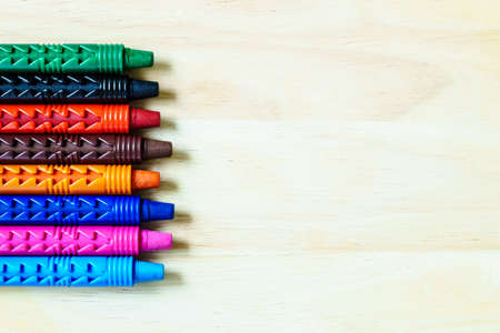 wax crayons on a wooden background with copy spaceの写真素材