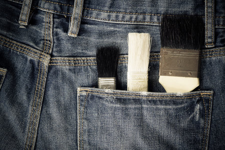 paint brushes in jeans pocketの写真素材