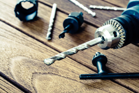 power drill closeup on wooden background