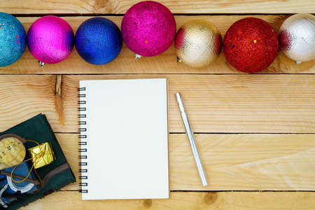 Greeting, Blank paper notebook With Christmas decoration on wooden Background with copy space for your textの写真素材