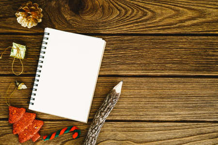 empty white space notebook with pencil and christmas ornament on wooden background with copy spaceの写真素材