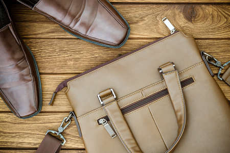 Still life with Brown leather shoes with leather bag on wooden tableの写真素材
