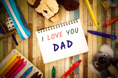 Fathers day greeting card concepts with I love you Mom text, crayons, toys and cute dolls. Top view on wooden background.の写真素材