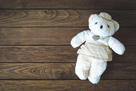 Cute teddy bear on wooden backgroundの写真素材