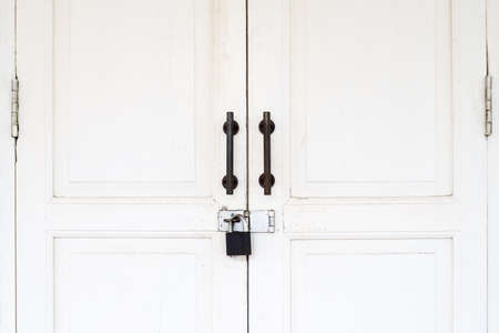 Old vintage white door with lockの写真素材