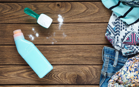 Pile of clothes with detergent and washing powder, top viewの写真素材