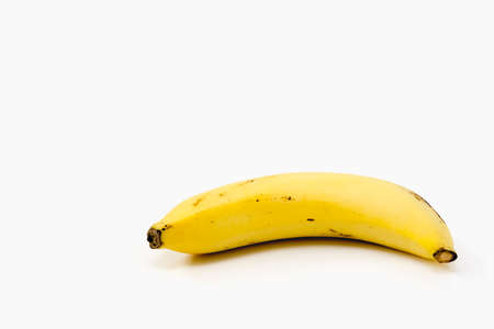 Ripe banana on white background - diet food concept with copy spaceの写真素材