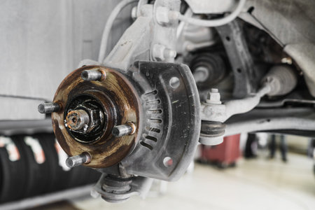 Auto Service, car disc brakes changing of lifted automobile at auto repair garage shop station