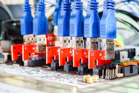 Close up of PCIE riser card plug to motherboard for mining rig machine to mine for digital cryptocurrency such as bitcoin, ethereum and other altcoins.の写真素材