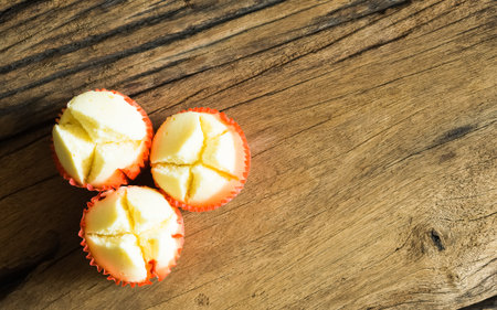 Top view of steamed cup cake or cotton wool cake on wood background, dessert for chinese new year festival.の写真素材