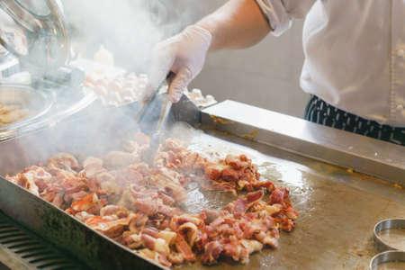 Chef is stirring beacon for american breakfastの写真素材