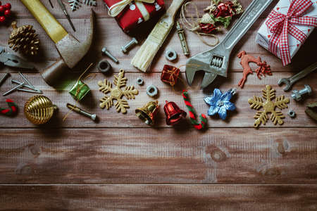 Merry christmas and Happy New year with handy tools  background concept, Used old rusty constructor tools with Christmas decoration on woodの写真素材