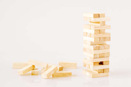 Wooden building blocks tower isolated on white background with copy space. Wood blocks stack game background concept for business risk, education, building, development, and growthの写真素材