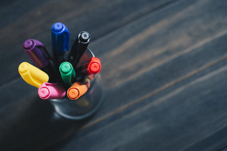 Close up selective focus of stack of Colored Pens Markers  In A Cup on the Dark Wooden Background with copy space for your text. Back to school and offices stationary concept.の写真素材