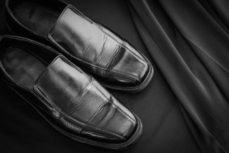 A pair of Black leather elegant  men shoes on black background. Gentleman Shoes Fashion Background.の写真素材