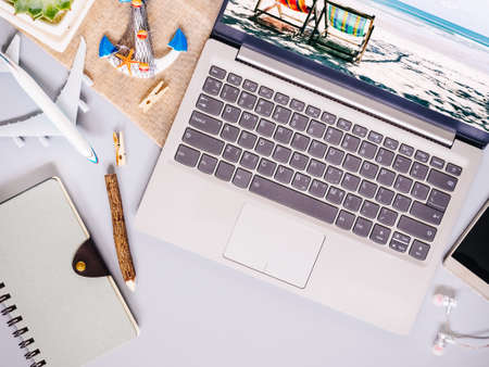 Top view of beach travel concept with laptop computer, notebook, smartphone, with copy space. Beach tropical travelling planning concept.の写真素材