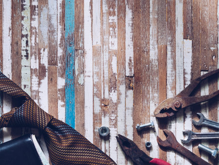 Variety rusty handy tools with necktie and wallet on grunge wooden background.  Labor day concept...