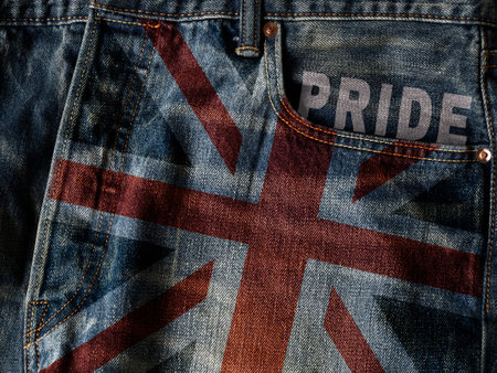 UK flag On Jeans Denim Texture with pride word. Closeup of United Kingdom flag or Union Jack flag on...