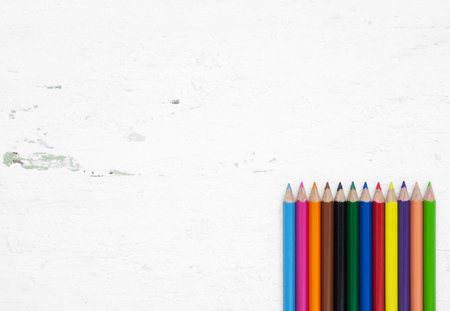 Colorful pencil crayons on a grunge white wood background with blank space, Back to school and...