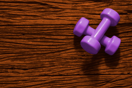 Fitness, Exercise, Working out healthy lifestyle background with Halloween color tone concept.  Flat lay Top view dumbbells on grunge wooden background with copy space for your text.の写真素材
