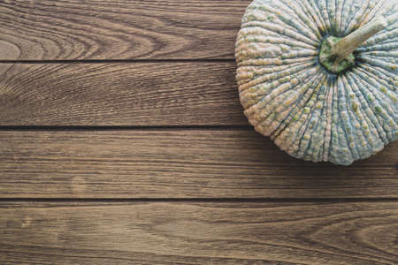 Top View of raw pumpkin on wooden table  background. Fresh organic vegetable, top view with copy space.の写真素材