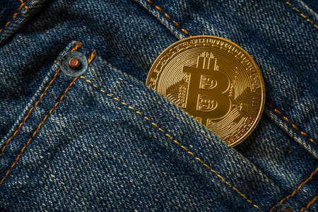 Close up of golden bitcoin in the denim jeans pocketの写真素材