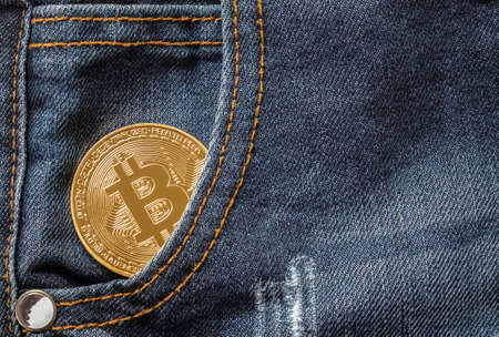 Close up of golden bitcoin in the denim jeans pocketの写真素材