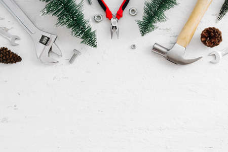 Merry Christmas and Happy new year handy tools and Christmas ornaments decoration on grunge white wood background concept. Top view with copy space.の写真素材