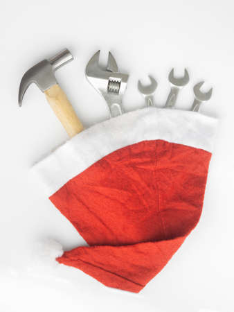 Hammer, adjustable wrench, wrenches in Santa Hat. Handy tools in Christmas festival background concept.の写真素材