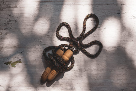 Still life shot of Jump rope or Skipping rope on grunge white wood background.