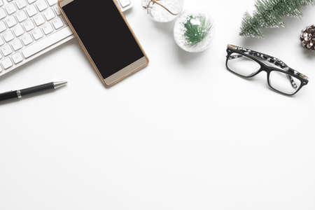 Merry Christmas and Happy new years office work space desktop concept. Flat lay top view with laptop notebook, smartphone, glasses and Christmas ornaments with copy space.の写真素材