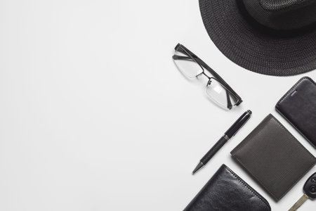 Flat lay top view gentlemen's accessories on white background with copy space. Hat, money pockets,...