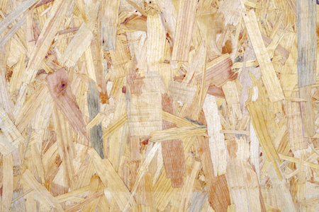 Close up of a recycled compressed light brown wood chippings board textured background. Abstract...