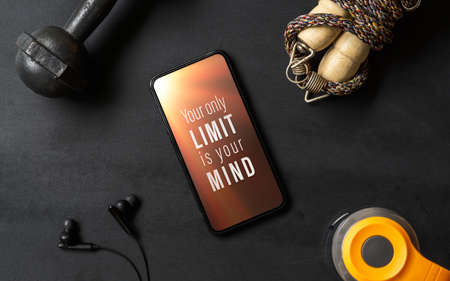 Your only limit is your mind. Inspirational motivational quotes fitness healthy goals with mockup mobile phone on grunge black table with dumbbells, Jump rope, bottle of water. Mock up smartphone for your artwork.の写真素材
