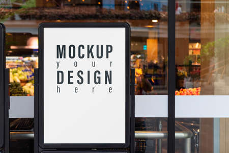 Mockup advertising board in front  of supermarket. Mock up billboard for your text message or mock up content with department store or shopping mall background.の写真素材