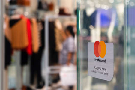 Bangkok, Thailand - September 22, 2019: Mastercard accepted and welcome sign in front of a clothing shopping store in in Bangkok, Thailand.のeditorial素材