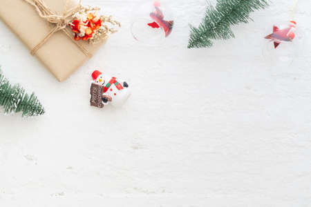 Natural Christmas gift box with pine tree and Christmas ornaments decoration on white snow wood background. Flat lay top view with copy space for your text.の写真素材