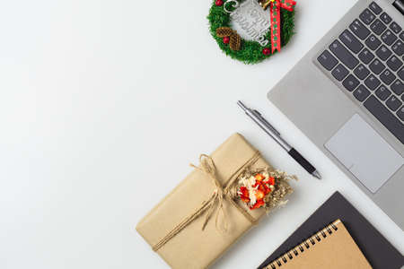 Merry Christmas and Happy new years office work space desktop concept. Flat lay top view with laptop, notebook and Christmas ornaments with copy space.の写真素材