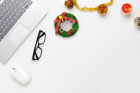 Merry Christmas and Happy new years office work space desktop concept. Flat lay top view with laptop and Christmas ornaments sign with copy space.の写真素材