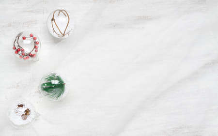 Merry Christmas and Happy New Year background. Christmas ornaments balls on nest fabric on wood background. Flat lay top view with copy space.の写真素材