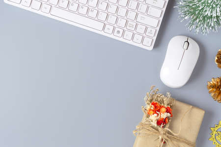 Merry Christmas and Happy new years office workspace desktop concept. Flat lay top view with keyboard, natural gift box and Christmas ornaments with copy space.の写真素材
