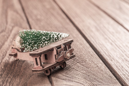 Christmas background with rustic vintage wooden airplane toy and pine tree. Decoration & Ornament...