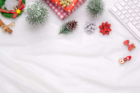 Merry Christmas and Happy new years office work space desktop concept. Flat lay top view with keyboard, blank notebook and Christmas ornaments with copy space.の写真素材