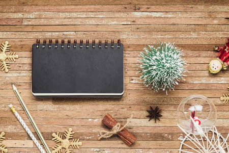 Top view of blank notebook on grunge wood  background with Christmas decorations. Mockup xmas background with notebook for wish list or to do list. Flat lay with copy space.の写真素材