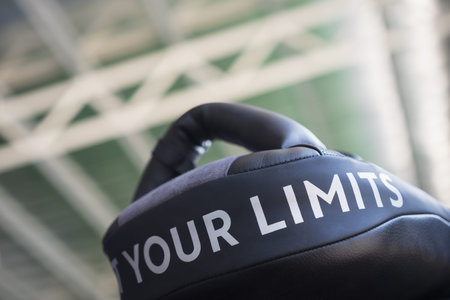Close up of YOUR LIMITS word on black boxing and kicking practice pad.
