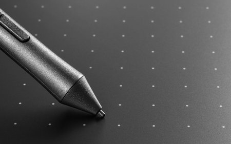 Close up shot of Graphic tablet with pen for illustrators and designers. Graphic design instrument.