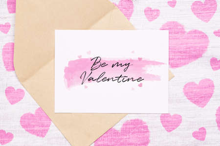 Mockup postcard and envelop on grunge white wood painted with pink heart and Be my Valentine text on postcard. Mock up for elegant design. Flat lay top view valentine's day background concept.の写真素材