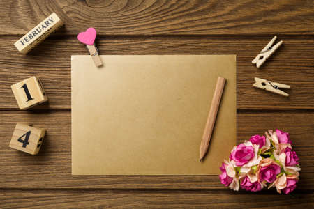 Mockup blank envelop on wood table for Valentine's Day. Mock up for elegant design. Flat lay top view valentine's day background concept.の写真素材